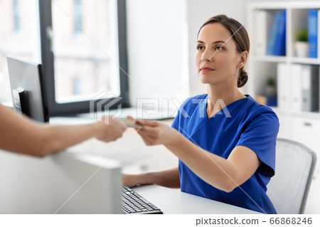 doctor and patient with credit card at hospital doctor and patient with credit card at hospital 66868246