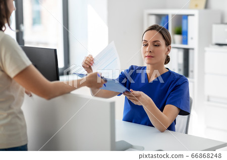 doctor with clipboard and patient at hospital doctor with clipboard and patient at hospital 66868248