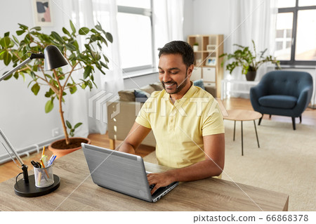 indian man with laptop working at home office indian man with laptop working at home office 66868378