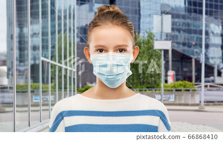 teenage girl in medical mask over city street 66868410