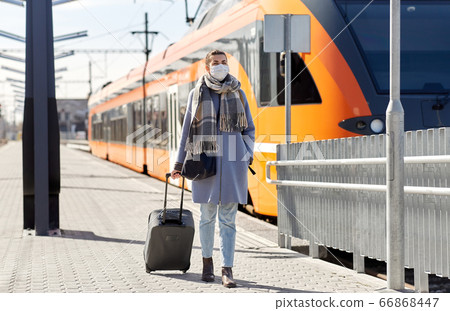 woman in protective face mask at railway station woman in protective face mask at railway station 66868447