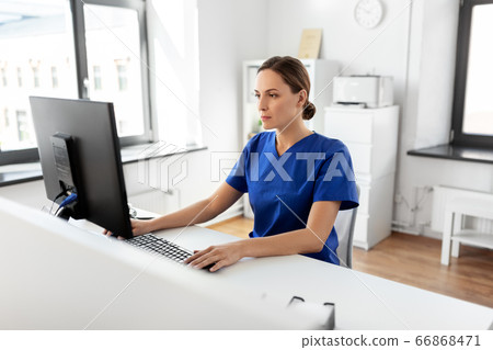 doctor or nurse with computer working at hospital doctor or nurse with computer working at hospital 66868471