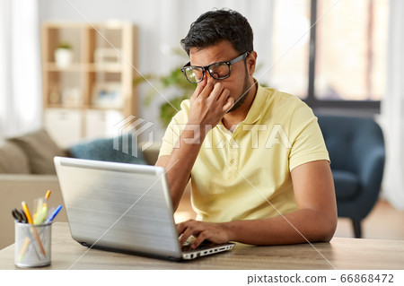 tired man with laptop working at home office tired man with laptop working at home office 66868472