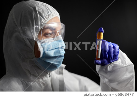 scientist in protective mask with test tube scientist in protective mask with test tube 66868477
