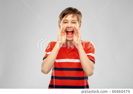 boy in red polo t-shirt shouting or calling boy in red polo t-shirt shouting or calling 66868479