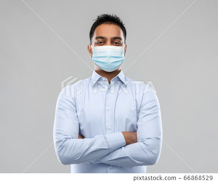 indian businessman in mask over grey background indian businessman in mask over grey background 66868529
