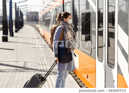 woman in protective face mask at railway station 66868533