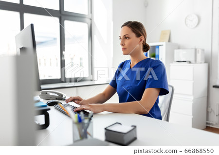 doctor or nurse with computer working at hospital 66868550