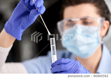 doctor holding beaker with coronavirus test 66868562