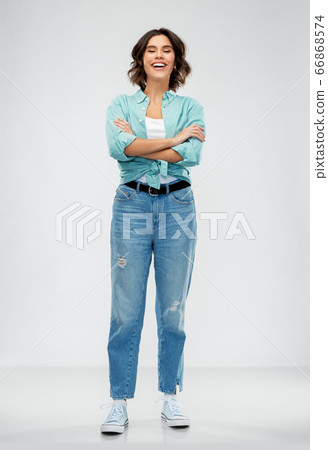smiling young woman in turquoise shirt and jeans smiling young woman in turquoise shirt and jeans 66868574