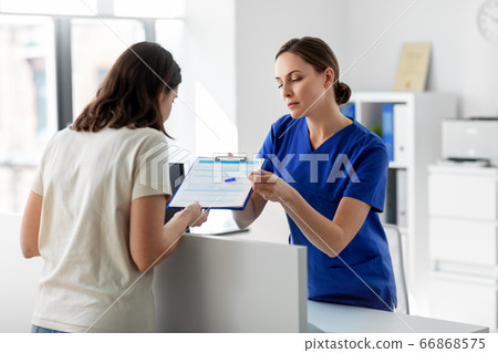 doctor with clipboard and patient at hospital doctor with clipboard and patient at hospital 66868575