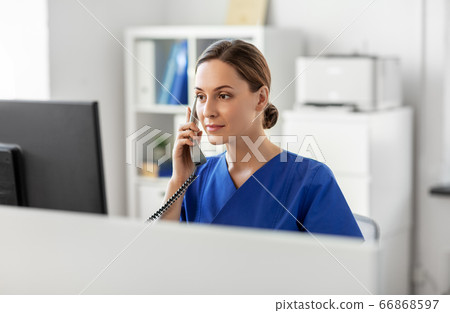 doctor with computer calling on phone at hospital 66868597
