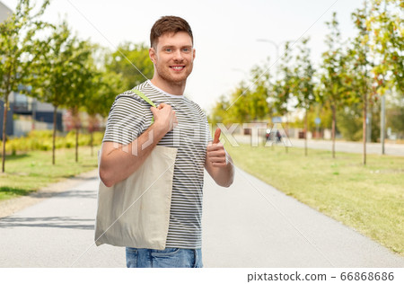 man with reusable canvas bag for food shopping 66868686