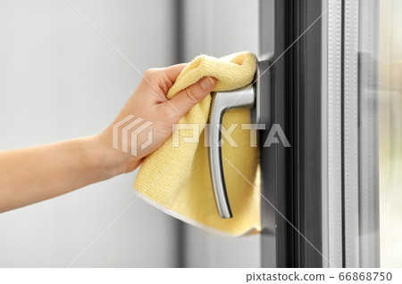 hand cleaning window handle with microfiber rag 66868750