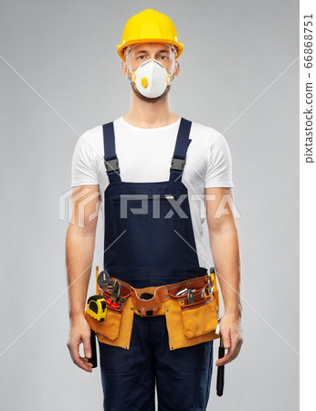 male worker or builder in helmet and respirator 66868751