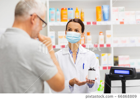 apothecary in mask showing drug to man at pharmacy apothecary in mask showing drug to man at pharmacy 66868809