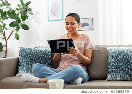 african american woman with tablet pc at home african american woman with tablet pc at home 66868879