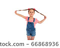 Cute small girl smailing and pulling her hair in the air, isolated on white background 66868936
