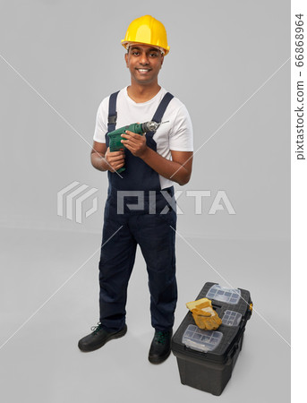 happy indian builder in helmet with electric drill happy indian builder in helmet with electric drill 66868964