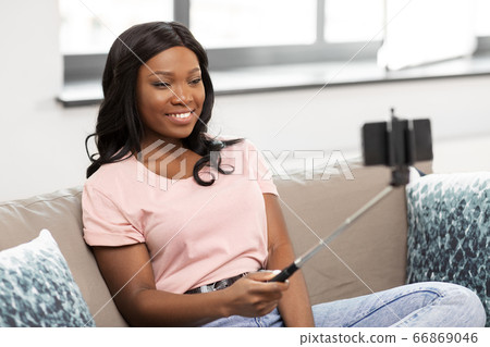 happy african american woman taking selfie at home happy african american woman taking selfie at home 66869046