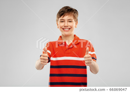 happy boy in red polo t-shirt showing thumbs up 66869047