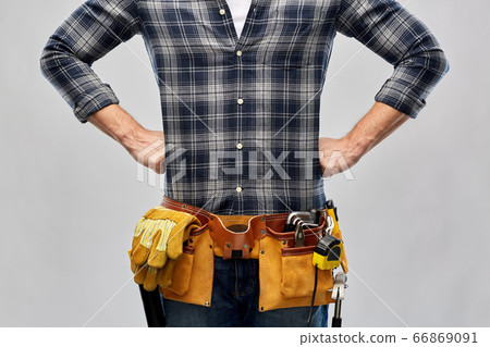 male worker or builder with working tools on belt 66869091
