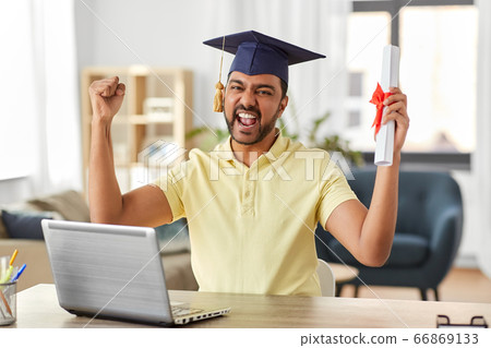 indian student with laptop and diploma at home 66869133
