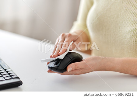 close up of woman cleaning computer mouse close up of woman cleaning computer mouse 66869221