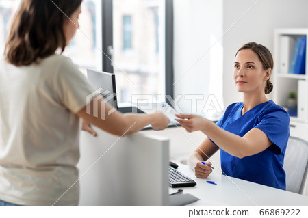 doctor and patient with prescription at hospital doctor and patient with prescription at hospital 66869222