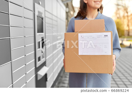 woman with boxes at automated parcel machine woman with boxes at automated parcel machine 66869224