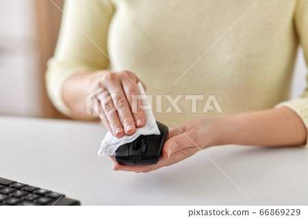 close up of woman cleaning computer mouse close up of woman cleaning computer mouse 66869229