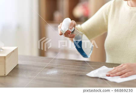 close up of woman cleaning table at home close up of woman cleaning table at home 66869230