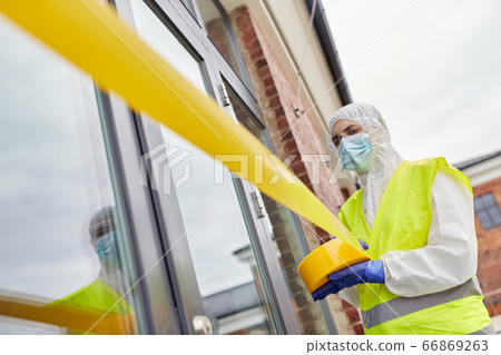 healthcare worker sealing door with caution tape healthcare worker sealing door with caution tape 66869263