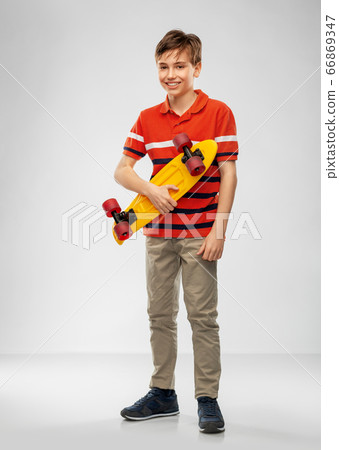 smiling boy with short skateboard smiling boy with short skateboard 66869347