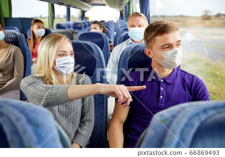 couple of passengers in masks in travel bus couple of passengers in masks in travel bus 66869493