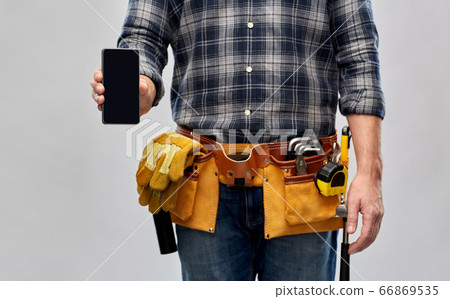 worker or builder with phone and working tools 66869535