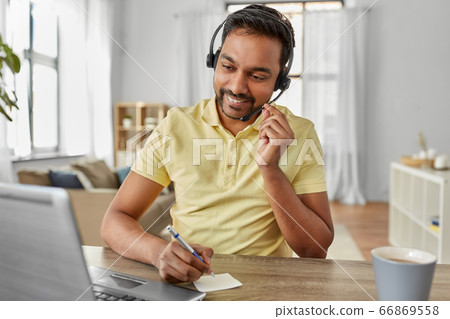 indian man with headset and laptop working at home 66869558