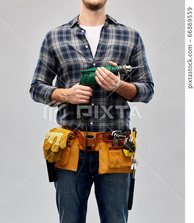 male repairer or builder with drill and work tools 66869559