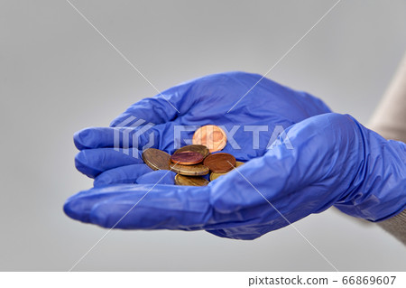 close up of hands in medical gloves with money 66869607