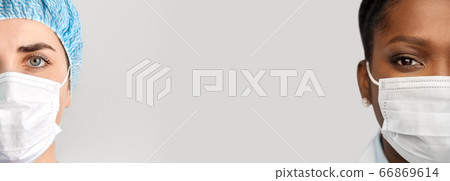 close up of doctor's faces in medical masks 66869614