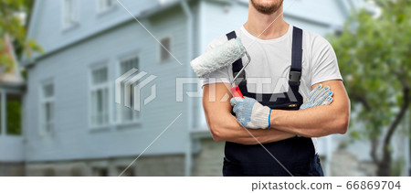 close up of painter or builder with paint roller close up of painter or builder with paint roller 66869704