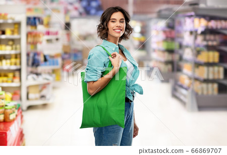 woman with reusable canvas bag for food shopping woman with reusable canvas bag for food shopping 66869707