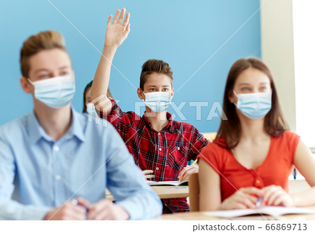 group of students in masks at school lesson 66869713