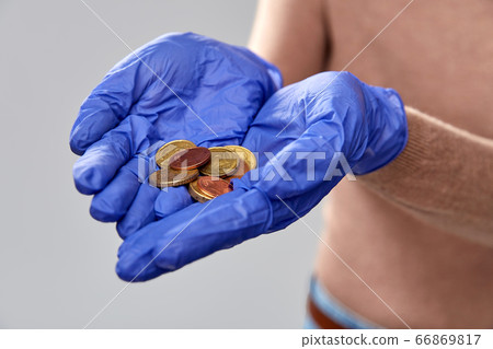close up of hands in medical gloves with money 66869817