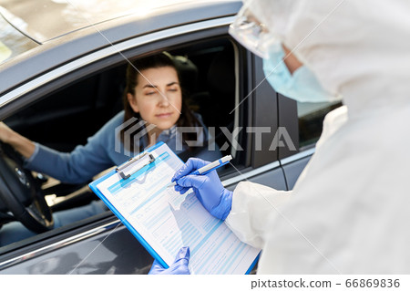 healthcare worker with clipboard and woman in car healthcare worker with clipboard and woman in car 66869836