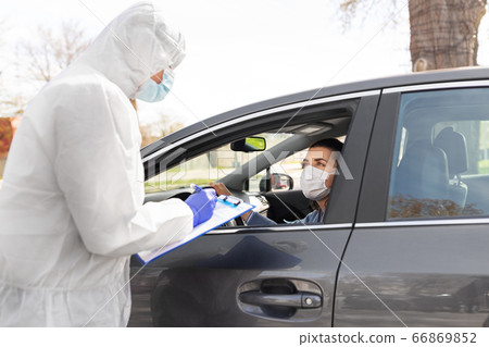 healthcare worker with clipboard and woman in car healthcare worker with clipboard and woman in car 66869852