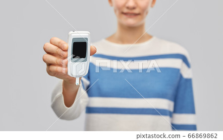 happy smiling teenage girl with glucometer happy smiling teenage girl with glucometer 66869862