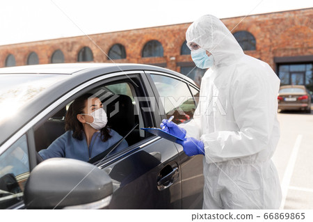 healthcare worker with clipboard and woman in car healthcare worker with clipboard and woman in car 66869865