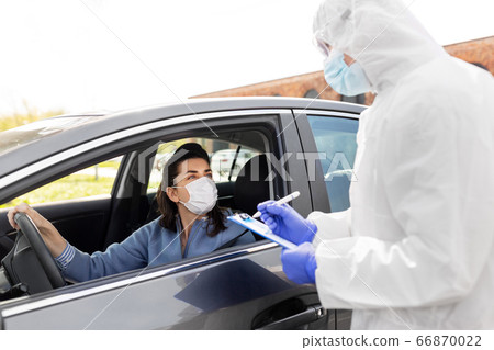 healthcare worker with clipboard and woman in car healthcare worker with clipboard and woman in car 66870022