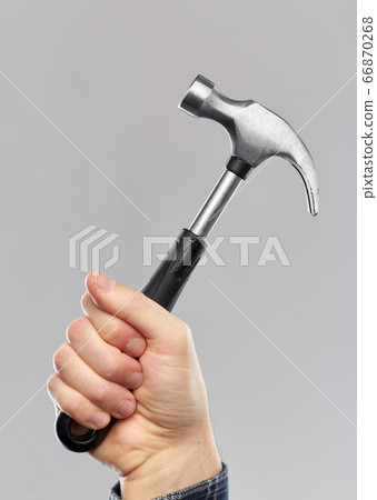 close up of builder's hand holding hammer close up of builder's hand holding hammer 66870268